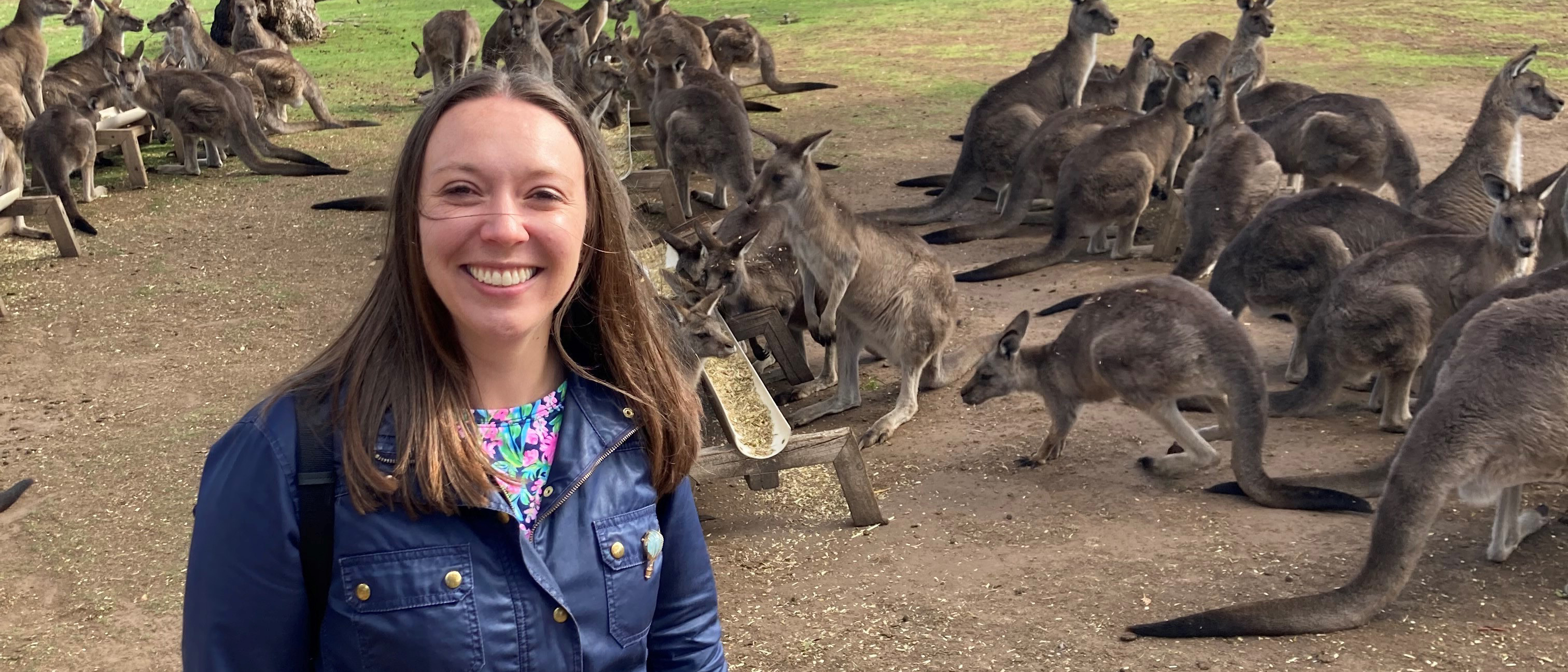 UNE professor Patricia Thibodeau poses with kangaroos in the background