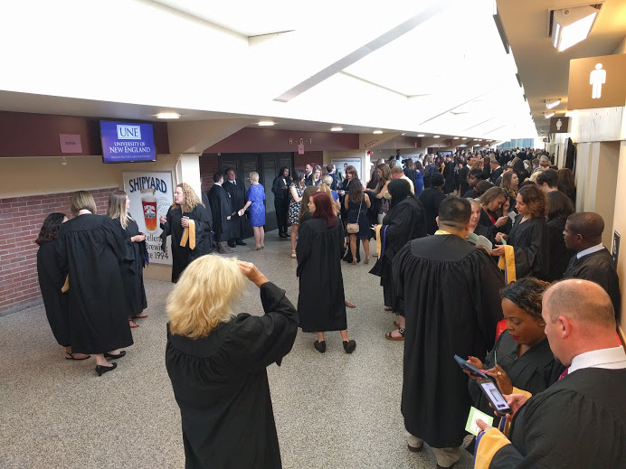 social work students line up in a hallway prior to the 2017 graduation hooding ceremony