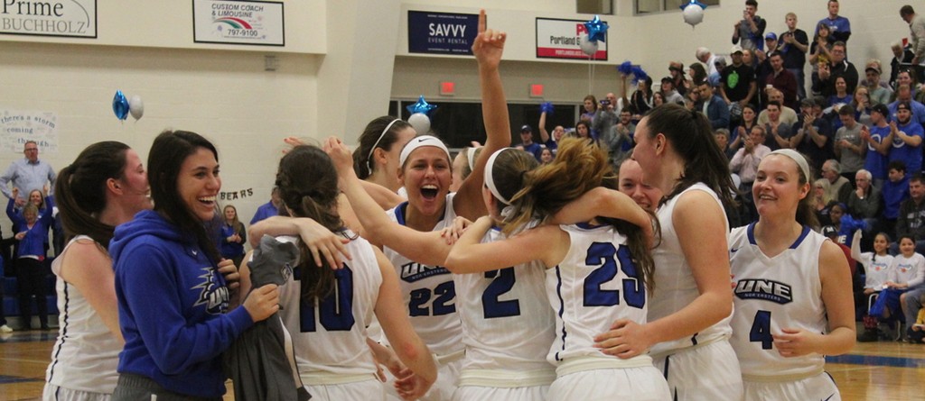 the women's basketball team celebrates a win on the court