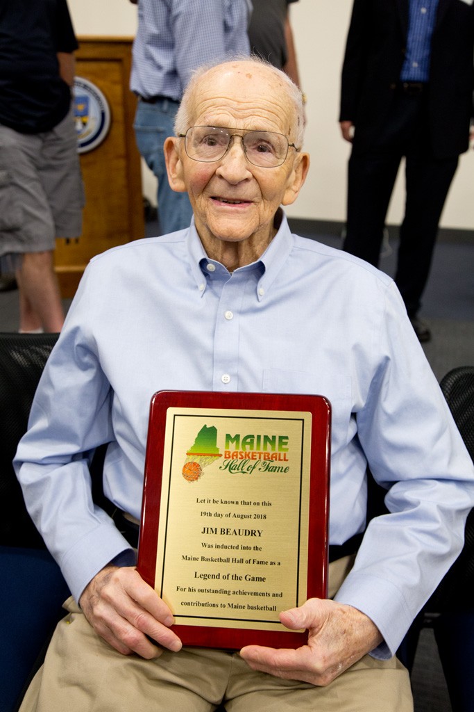 Beaudry displays his Maine Basketball Hall of Fame plaque at the induction ceremony.