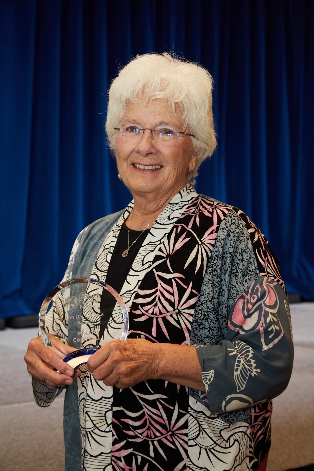 Polly Campbell poses with the Kim Day Service Award 