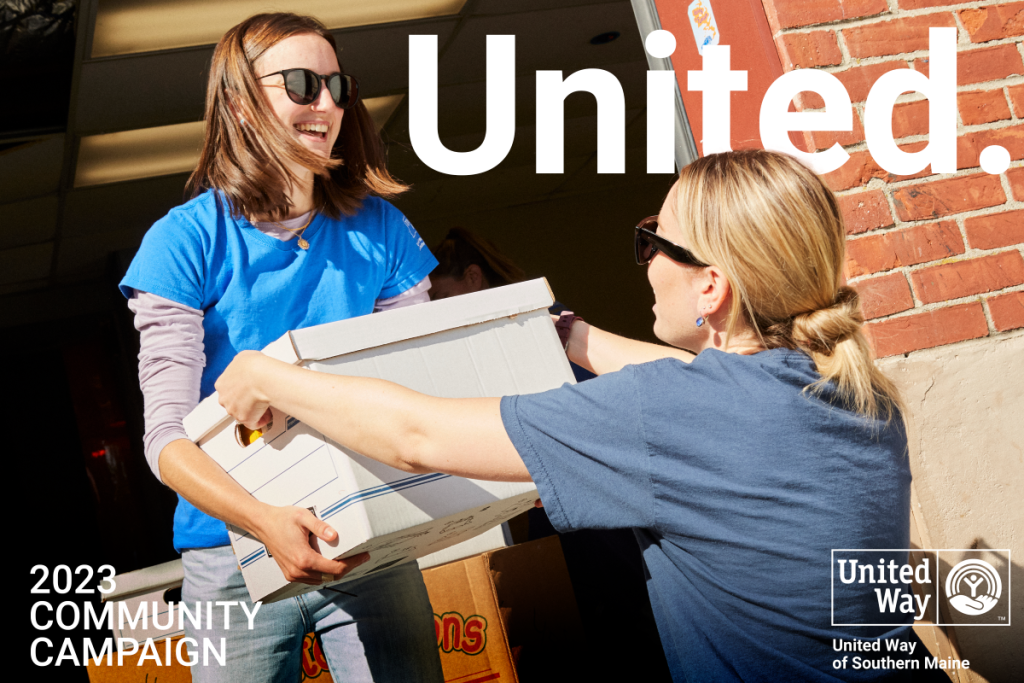Two volunteers for United Way moving boxes