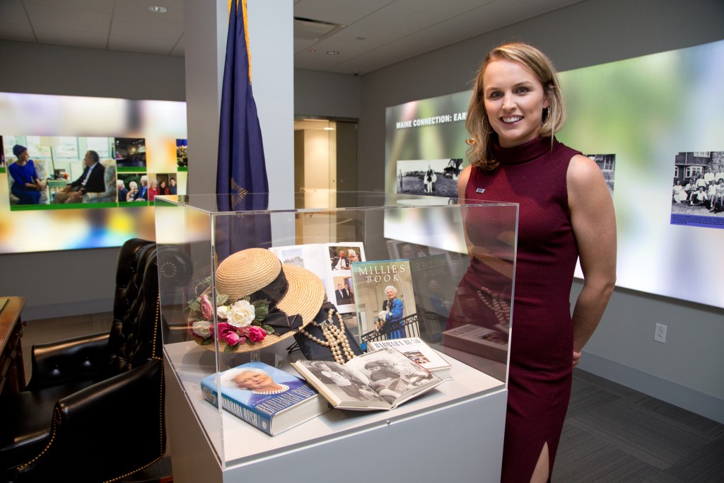 Ellie LeBlond Sosa poses next to items that belonged to her grandmother, Barbara Bush, in UNE's Bush Legacy Collection 