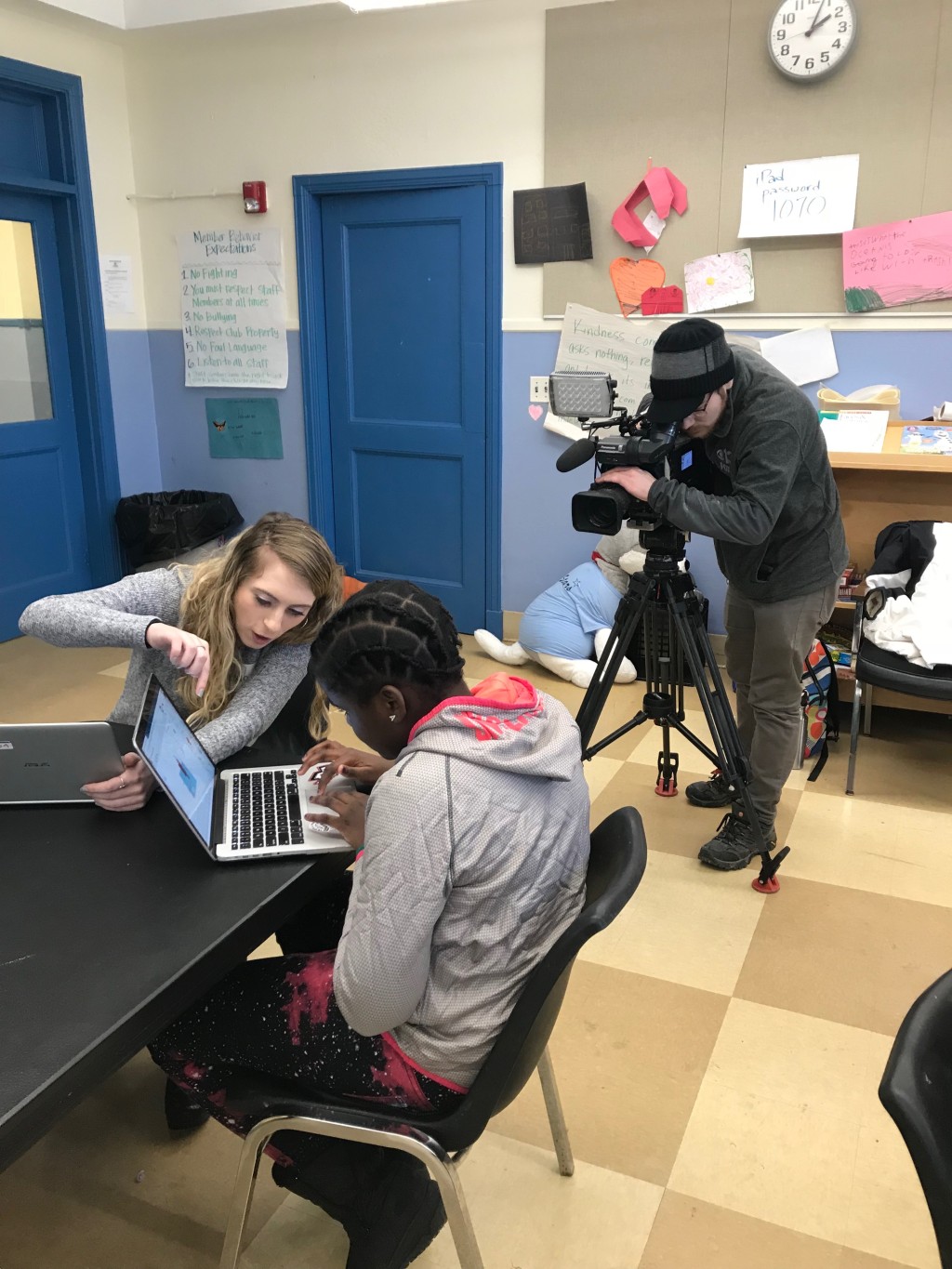A WGME videographer captures Paige Hibbard assisting a student for a segment in the evening news