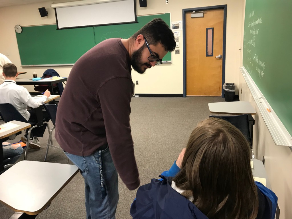 Education student Anthony Meloniates assists a middle school student during a breakout session