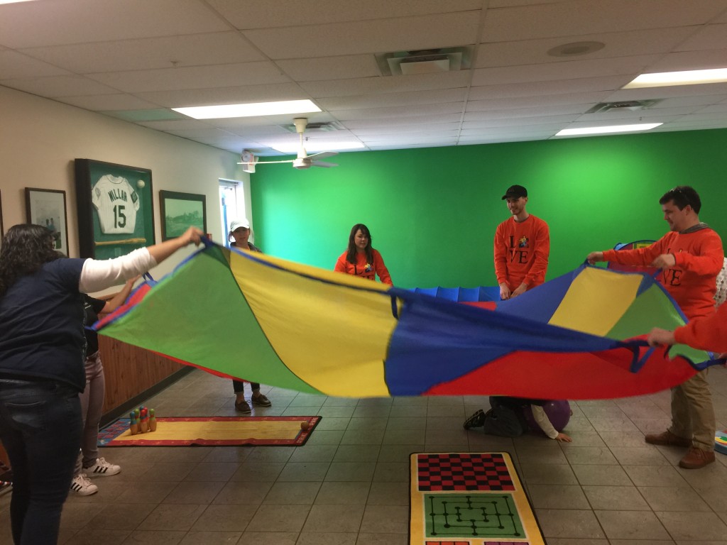 Parachute play with UNE OT volunteers in the Seadogs sensory room
