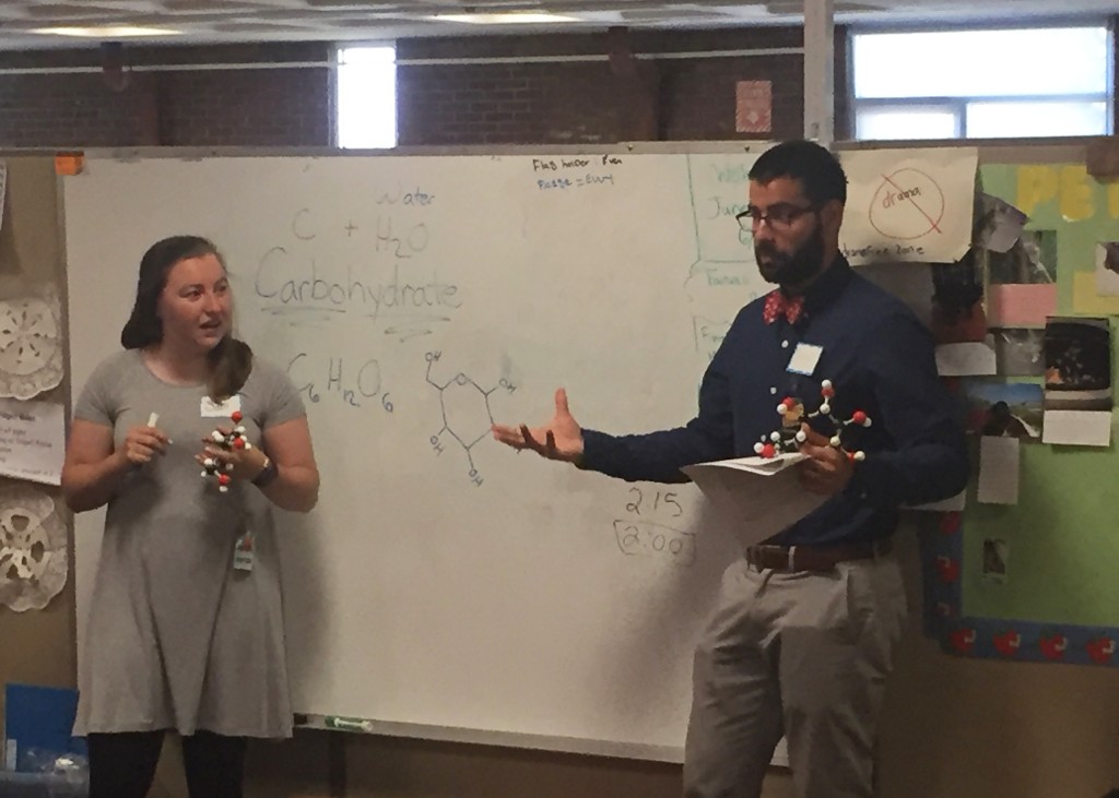 Samantha Mansberger and Bruno DeMaria teach with molecular models.