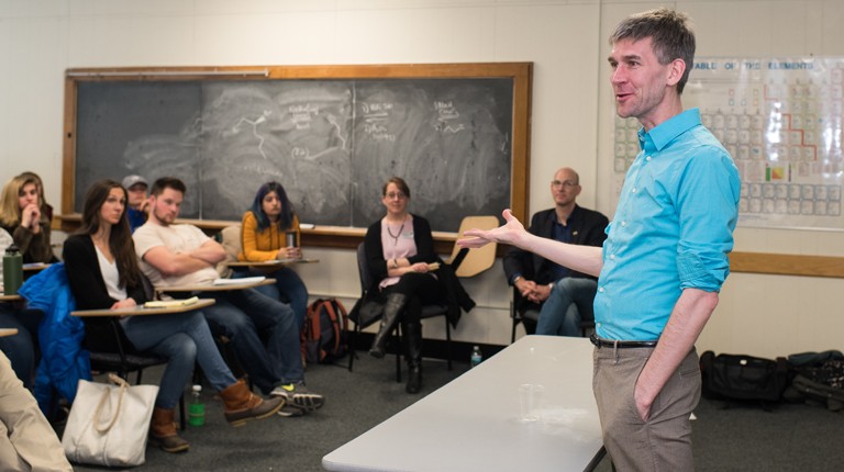 Professor speaking to students in a classroom