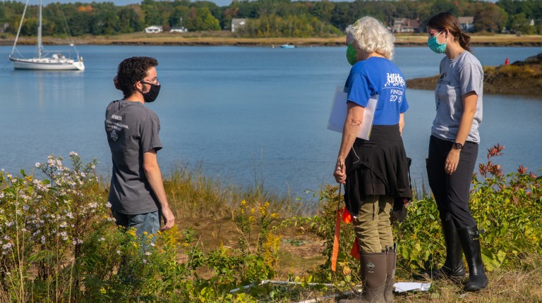 Students survey the marshland on campus