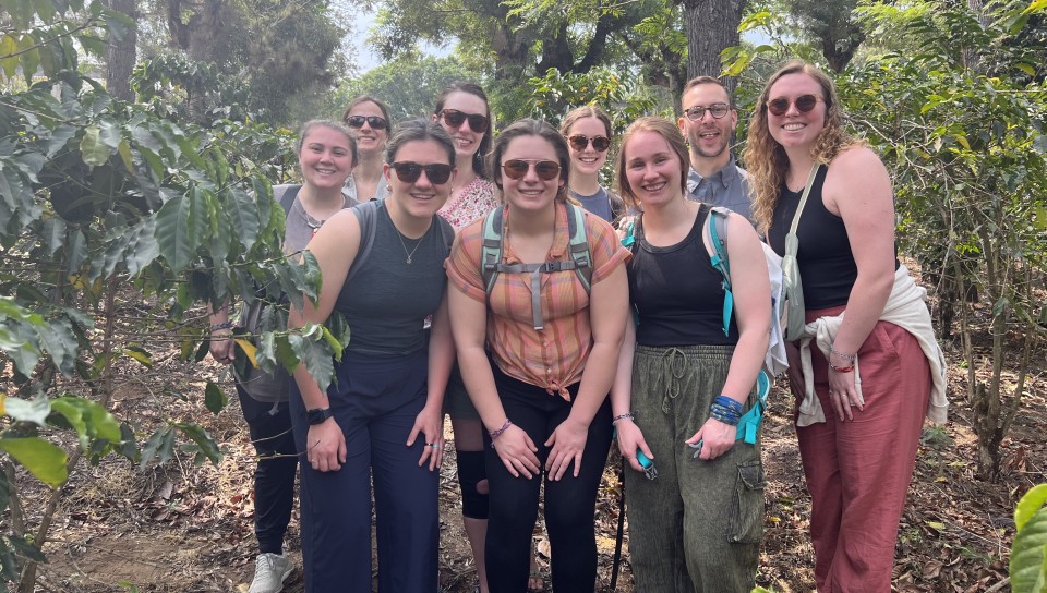 The group poses while on a hike in the jungle