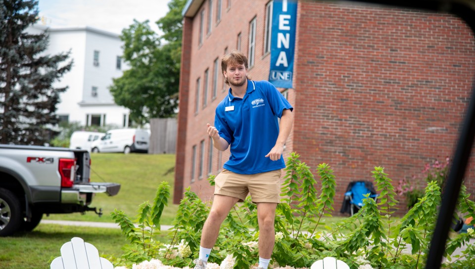 A student orientation leader dances in the first-year quad