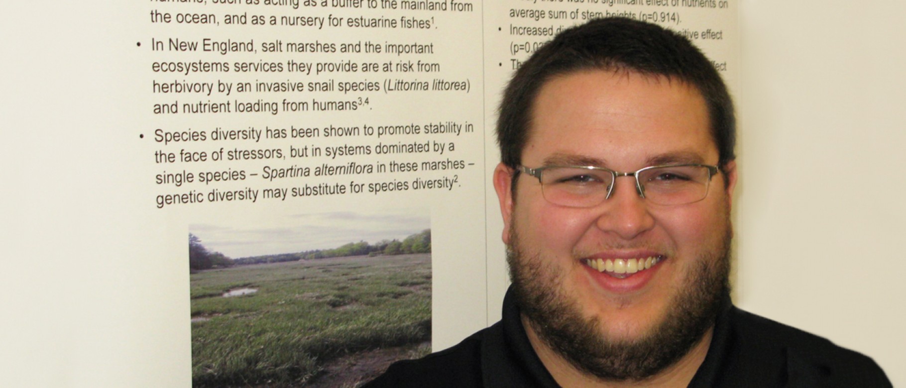 Student Eric Scouten stands with his research poster