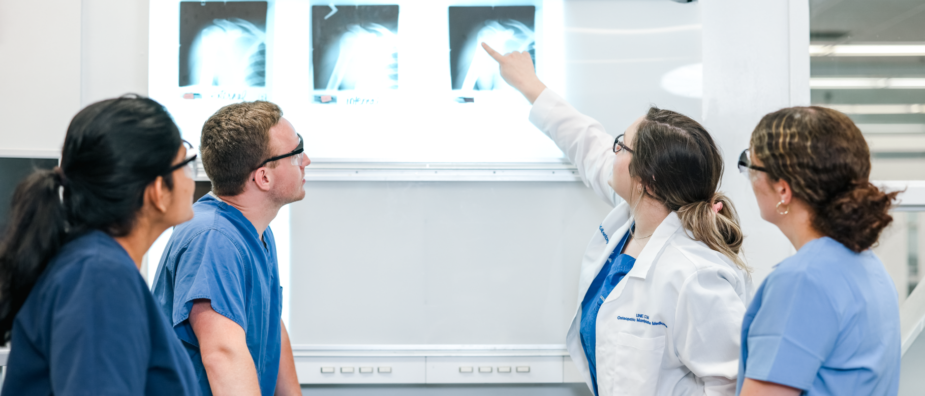 Medical students examine an x-ray in a lab