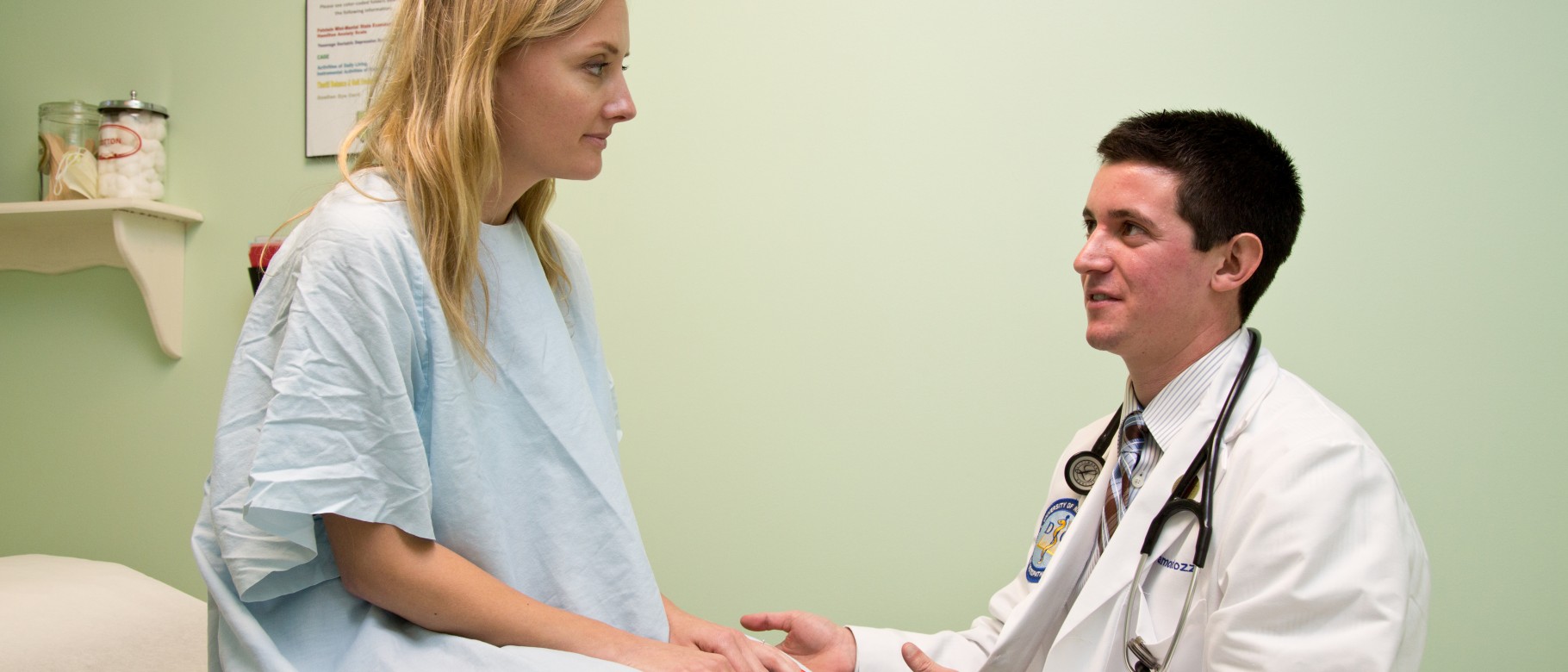 A student in the College of Osteopathic Medicine attends to a patient.