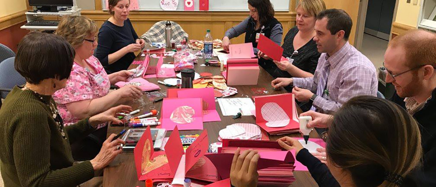 Students from the College of Pharmacy make cards with Maine Medical Center staff