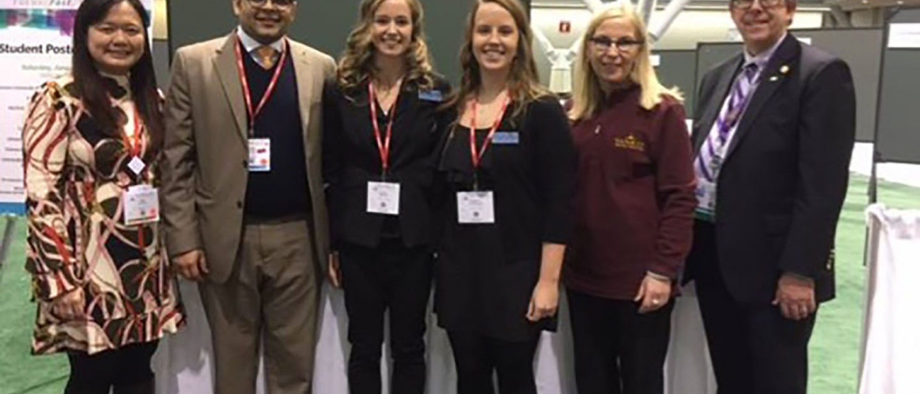 Christen Cavanaugh and Tiana Thomas with Yankee Dental Congress poster session judges 