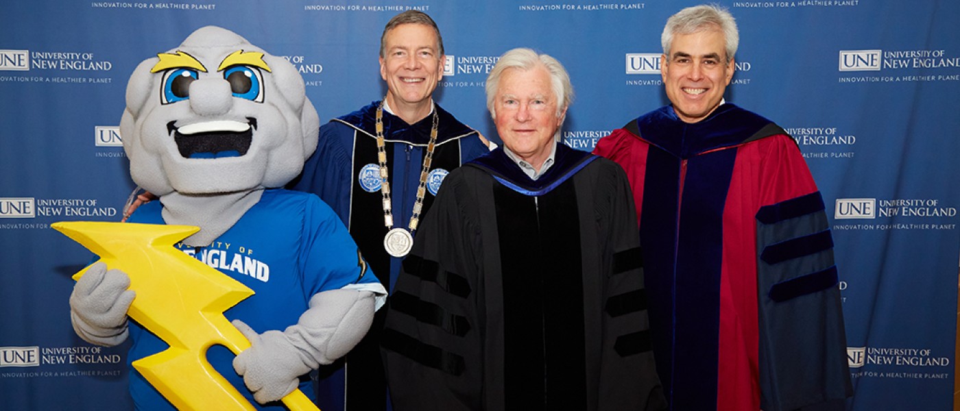 UNE President James Herbert, David Evans Shaw, and Commencement speaker Jonathan Haidt pose with UNE's mascot, Stormin' Norman