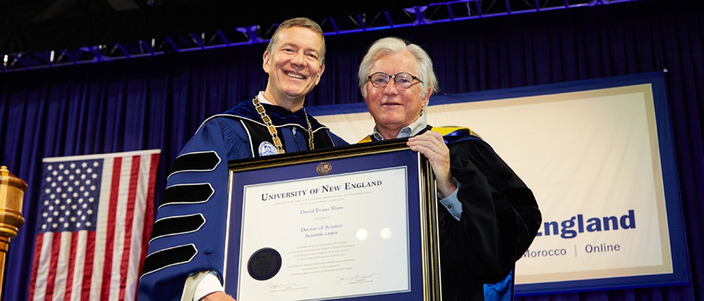 UNE President James Herbert presents an honorary degree to David Evans Shaw