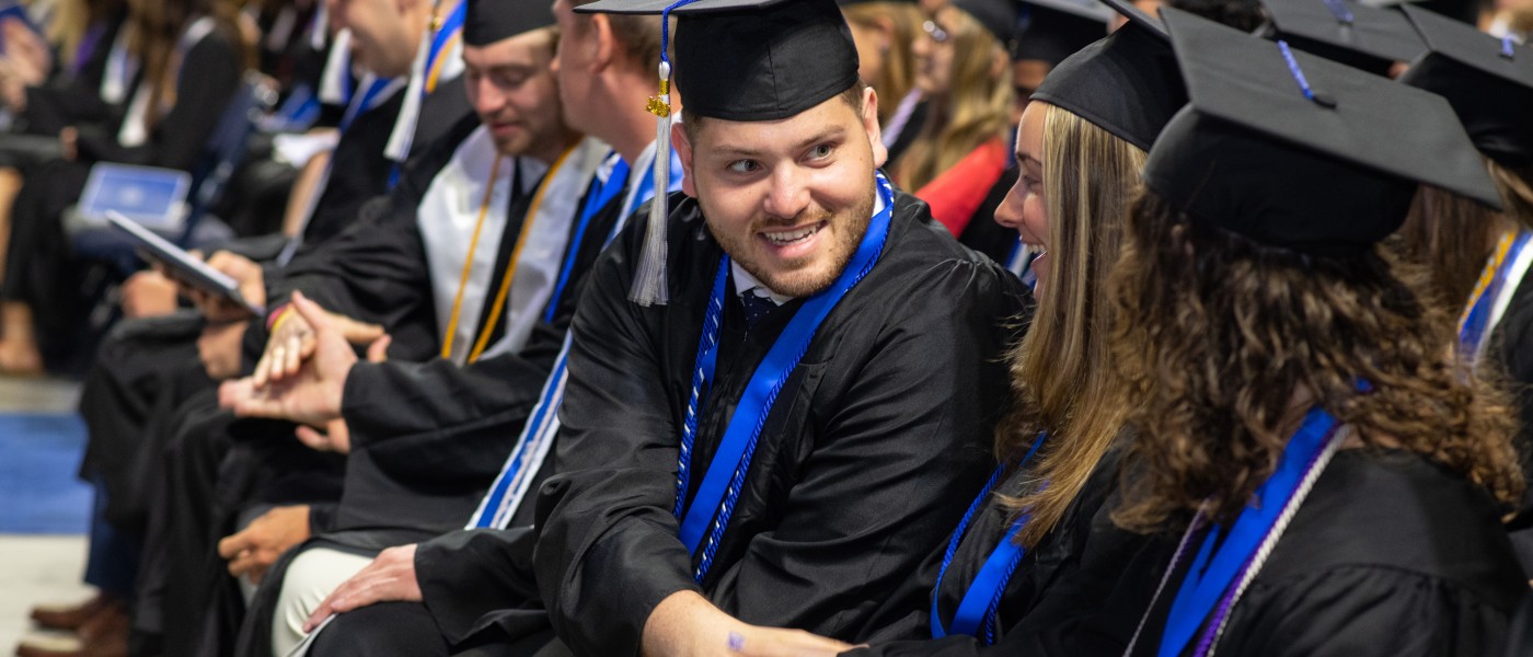UNE graduates sit at the Cross Insurance Arena in Portland