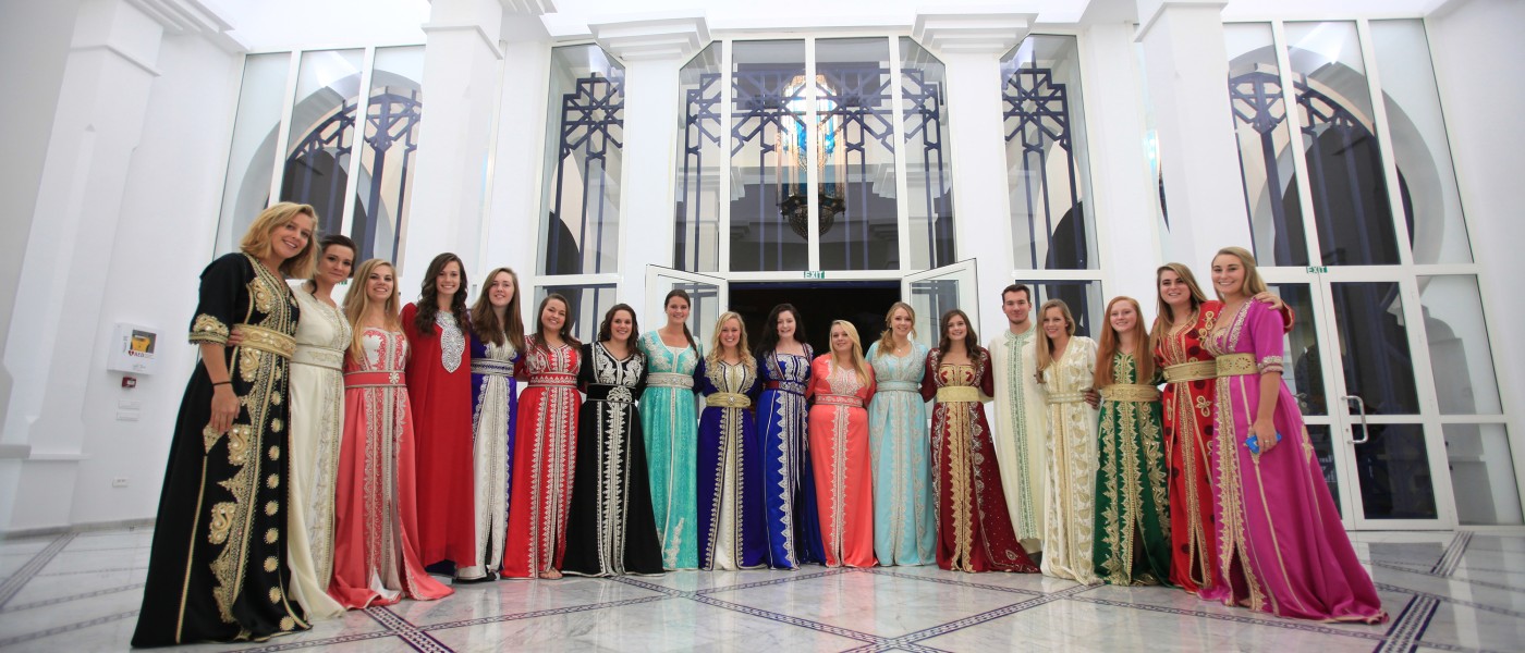 U N E students dress in traditional Moroccan clothing to host a party with local college students.