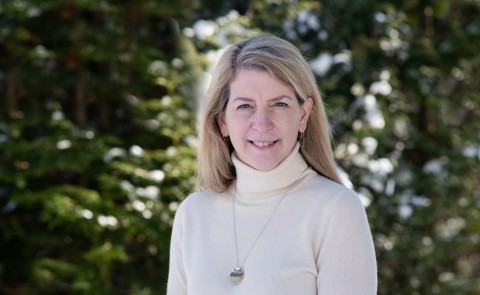 Beth Taylor-Nolan, new dean of UNE Online, poses for a portrait against the trees