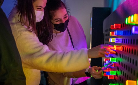 Students play with a giant "Lite Brite" at the children's museum
