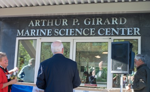 Arthur Girard looks up as the center's new name is revealed
