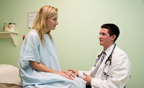 A student in the College of Osteopathic Medicine attends to a patient.