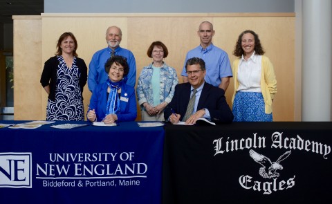 L-R seated: Jeanne Hey, Ph.D., dean of UNE’s College of Arts and Sciences; David Sturdevant, head of school, Lincoln Academy; L-