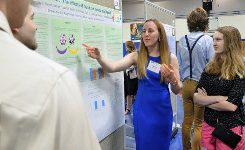 Courtney Parent '19 explains the research on her team's poster