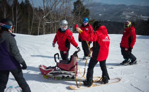 Julia Currier (wearing the silver helmet) at her internship site at Maine Adaptive & Recreation, housed at Sunday River ski reso