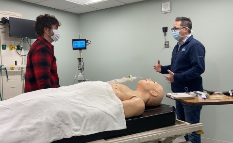 Baxter Academy engineering teacher Jon Amory chats with UNE's Neill Gemmel in the simulation lab