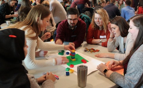 Students from various colleges within the University of New England work together during a collaborative learning activity.