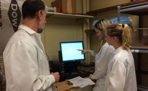 Glenn Stevenson works with students Katherine Cone and Abigail Kinens in the lab.