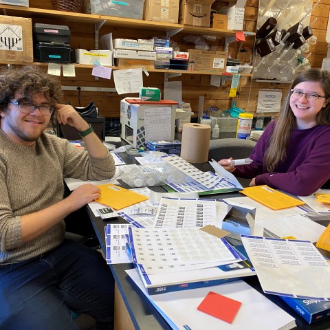 UNE student Brooke Parks sits with MDI Biological Laboratory independent study student, Adam Feher.