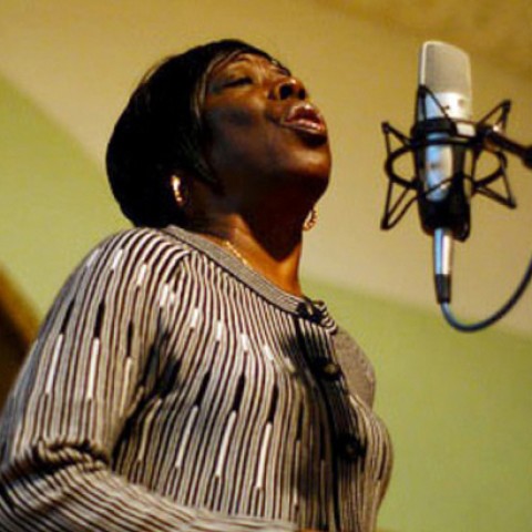 Bettie Mae Fikes sings into a microphone