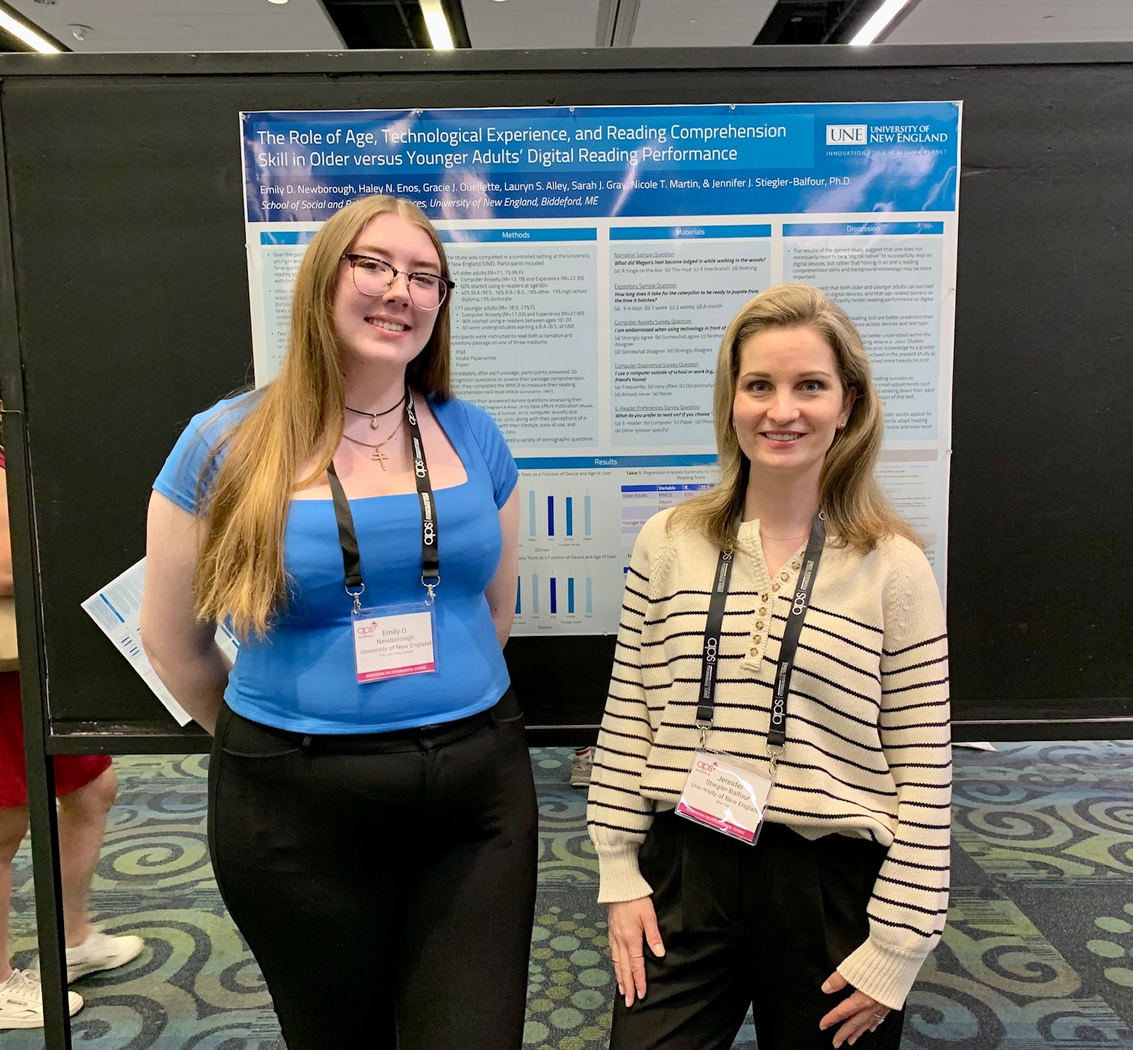 Emily Newborough poses with Jennifer Stiegler-Balfour in front of their research poster