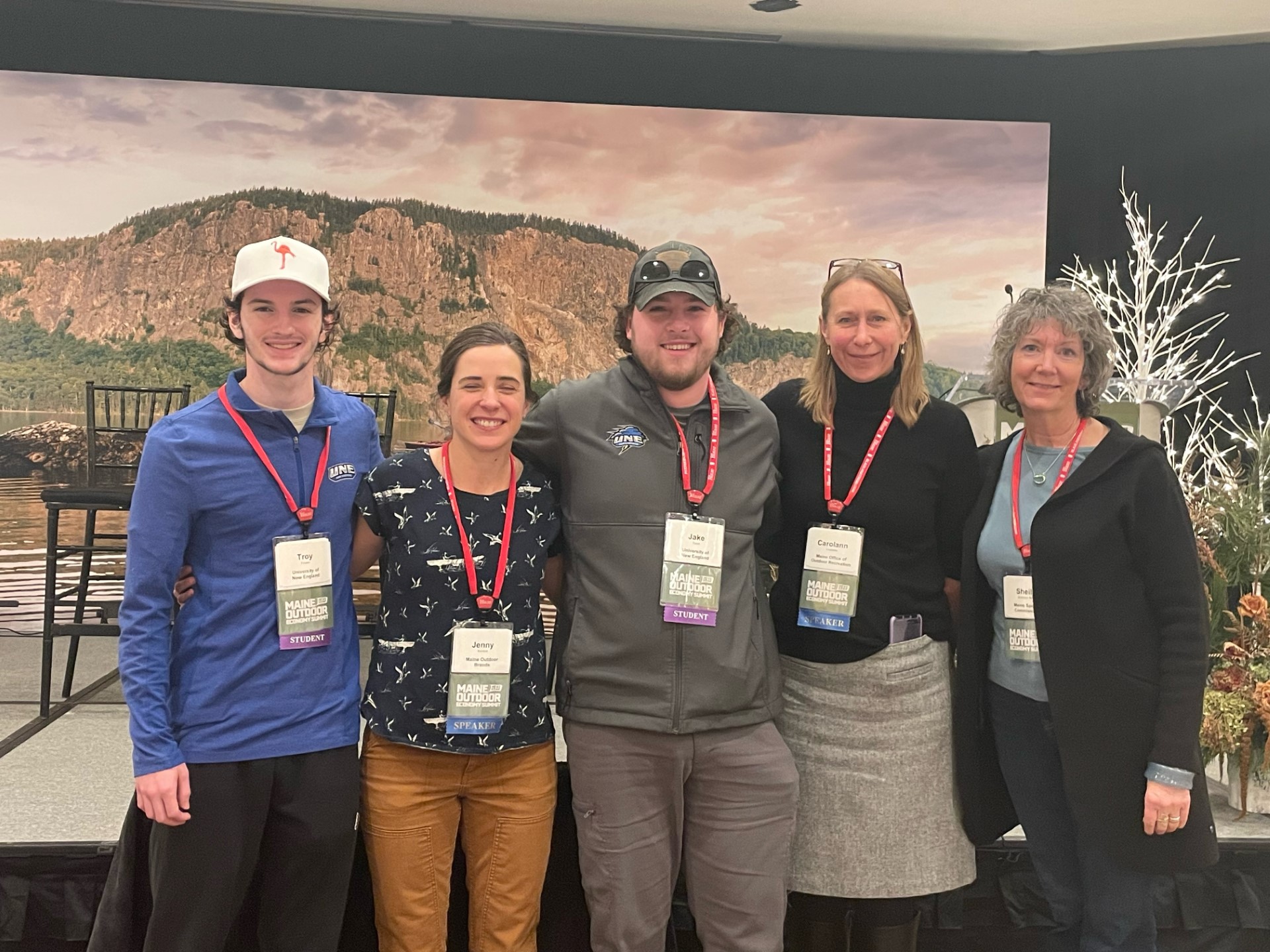 UNE students Troy Fowler and Jake Tobin pose with representatives from Maine's outdoor economy at the Maine Outdoor Economy Summit in Rockland