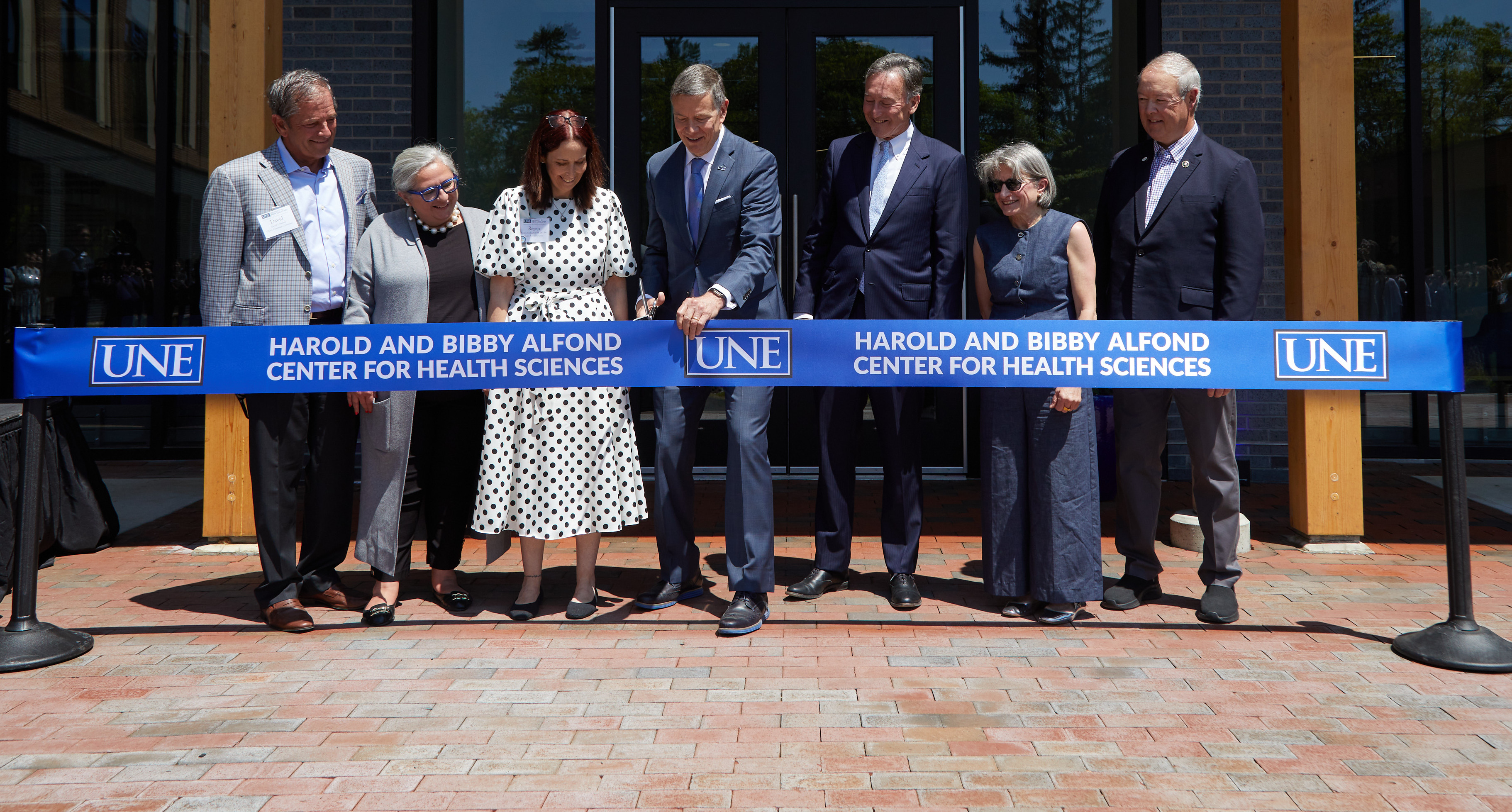UNE administrators and trustees cut the ribbon for the Harold and Bibby Alfond Center for Health Sciences