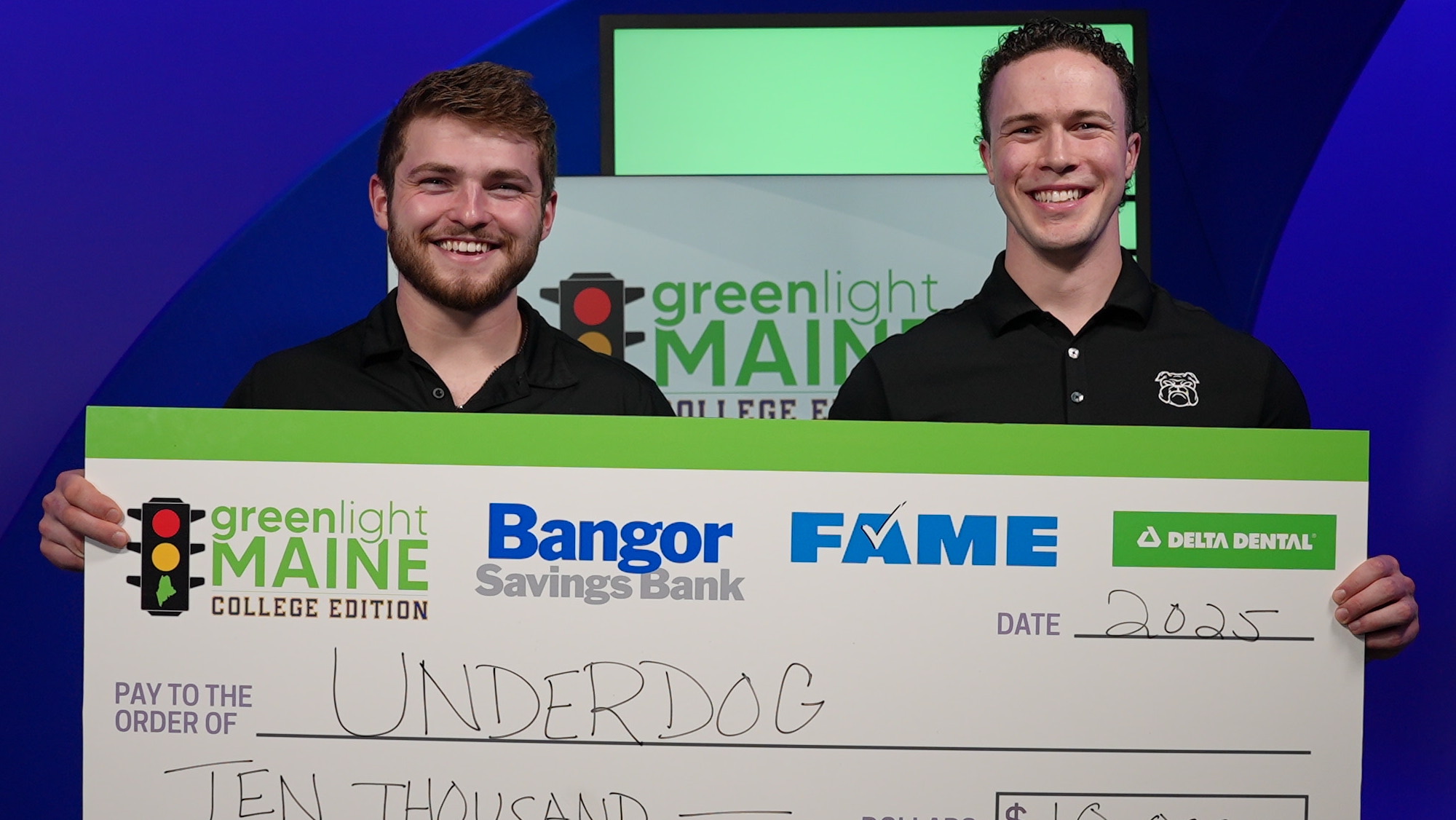 Joey Stanizzi and Dylan Schuett ’25 hold a large check for their Greenlight Maine win