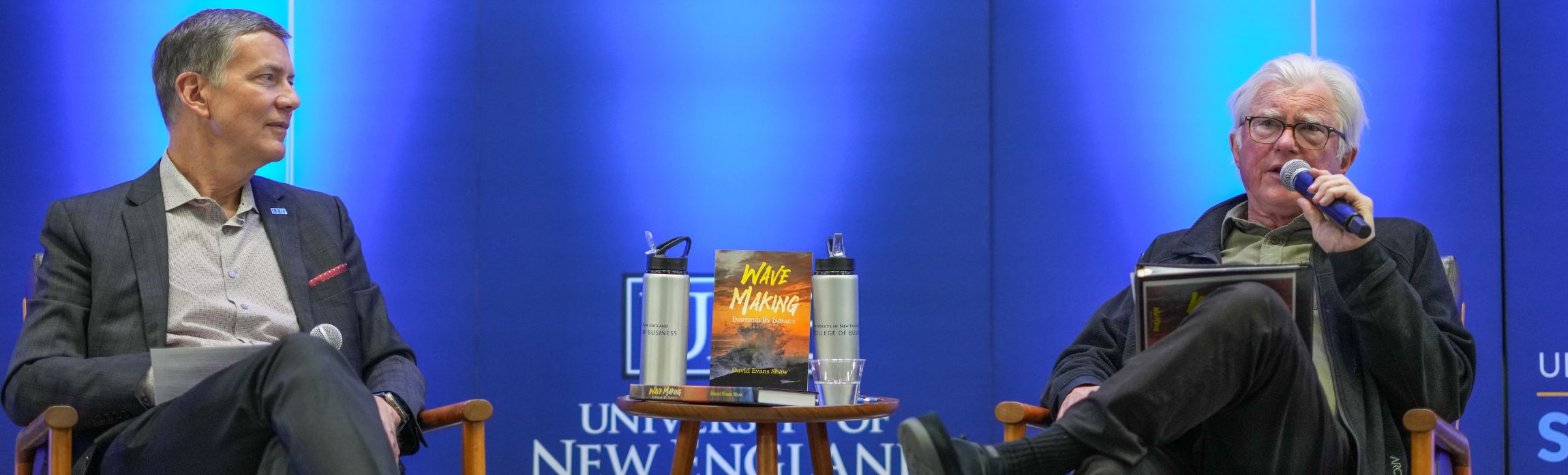 President Herbert on left with David Shaw on right speaking into micorphone