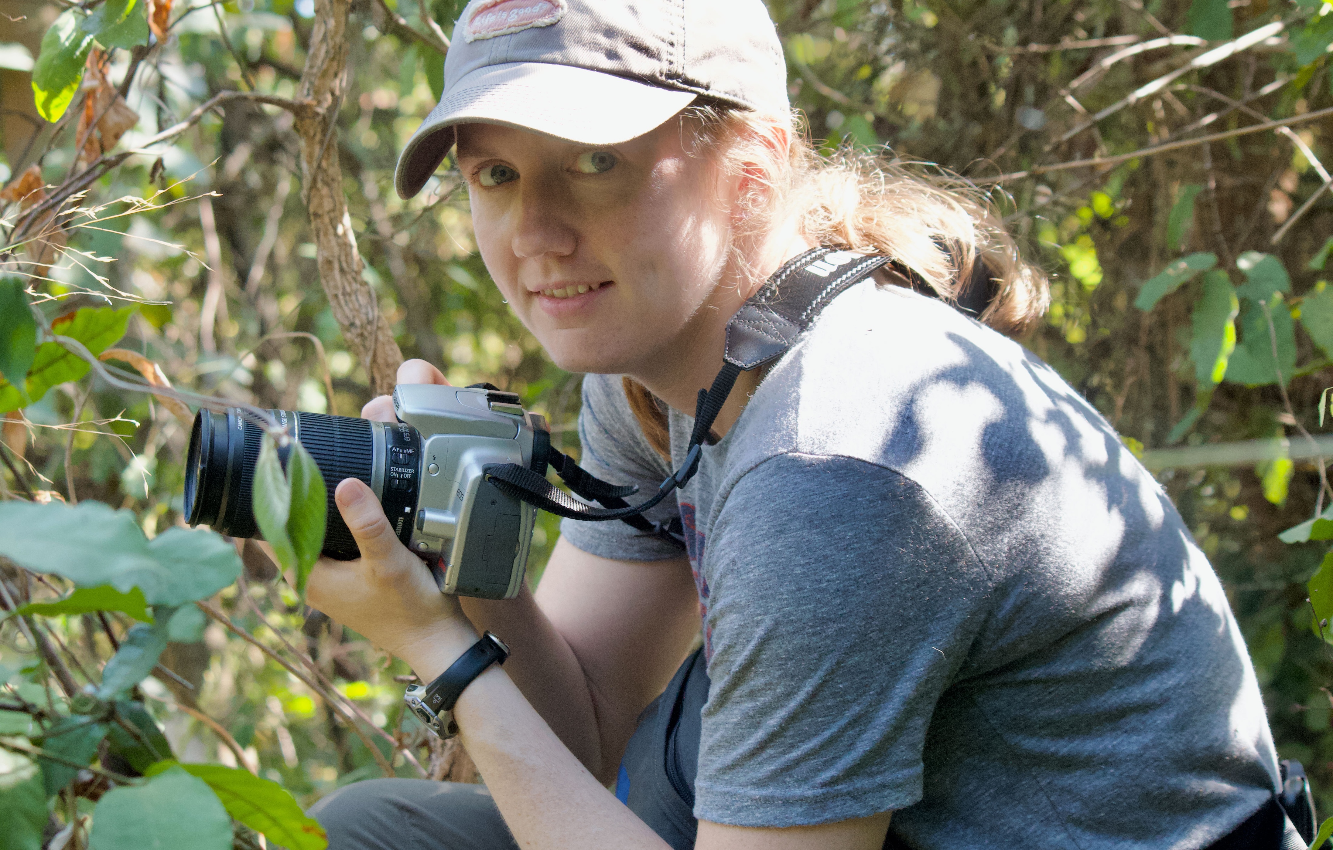 UNE faculty member Maggie Stanton holds a camera in Gombe National Park