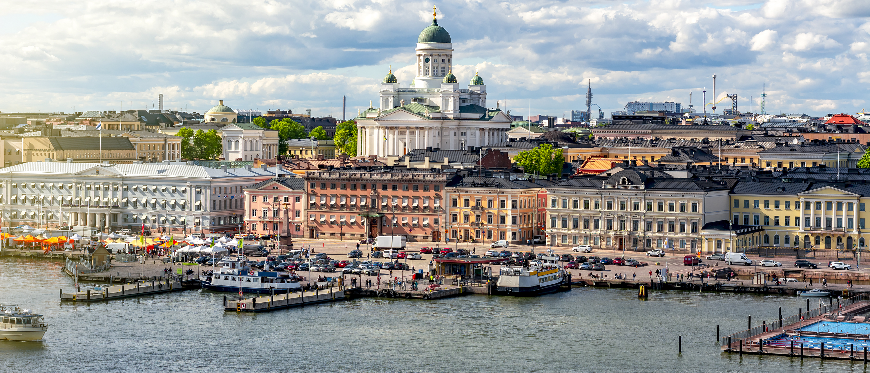 A waterfront view of Helsinki, Finland, with Helsinki Cathedral rising above the harbor.