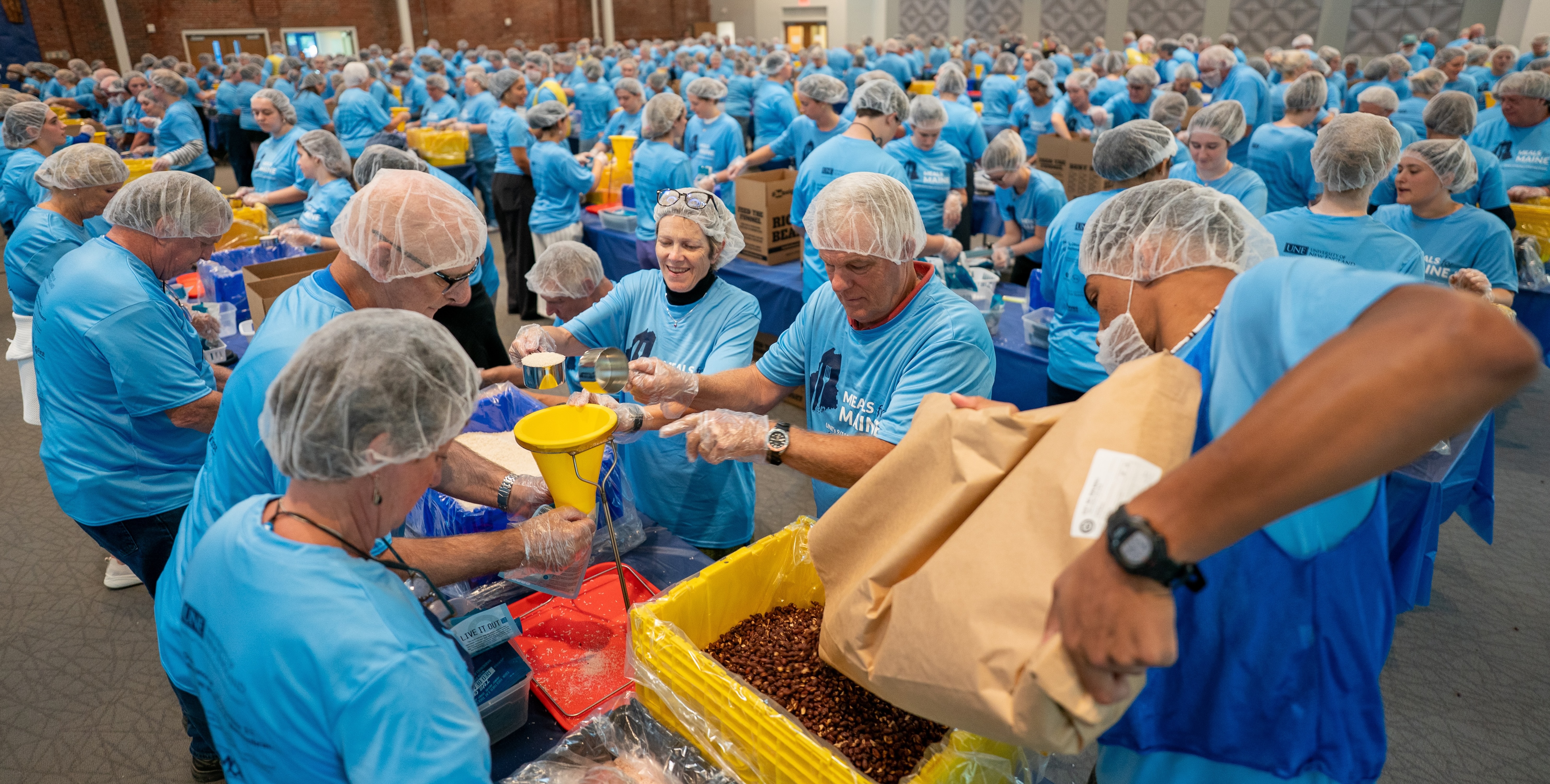 UNE community volunteers pack a record 200,000 meal kits to combat hunger across Maine