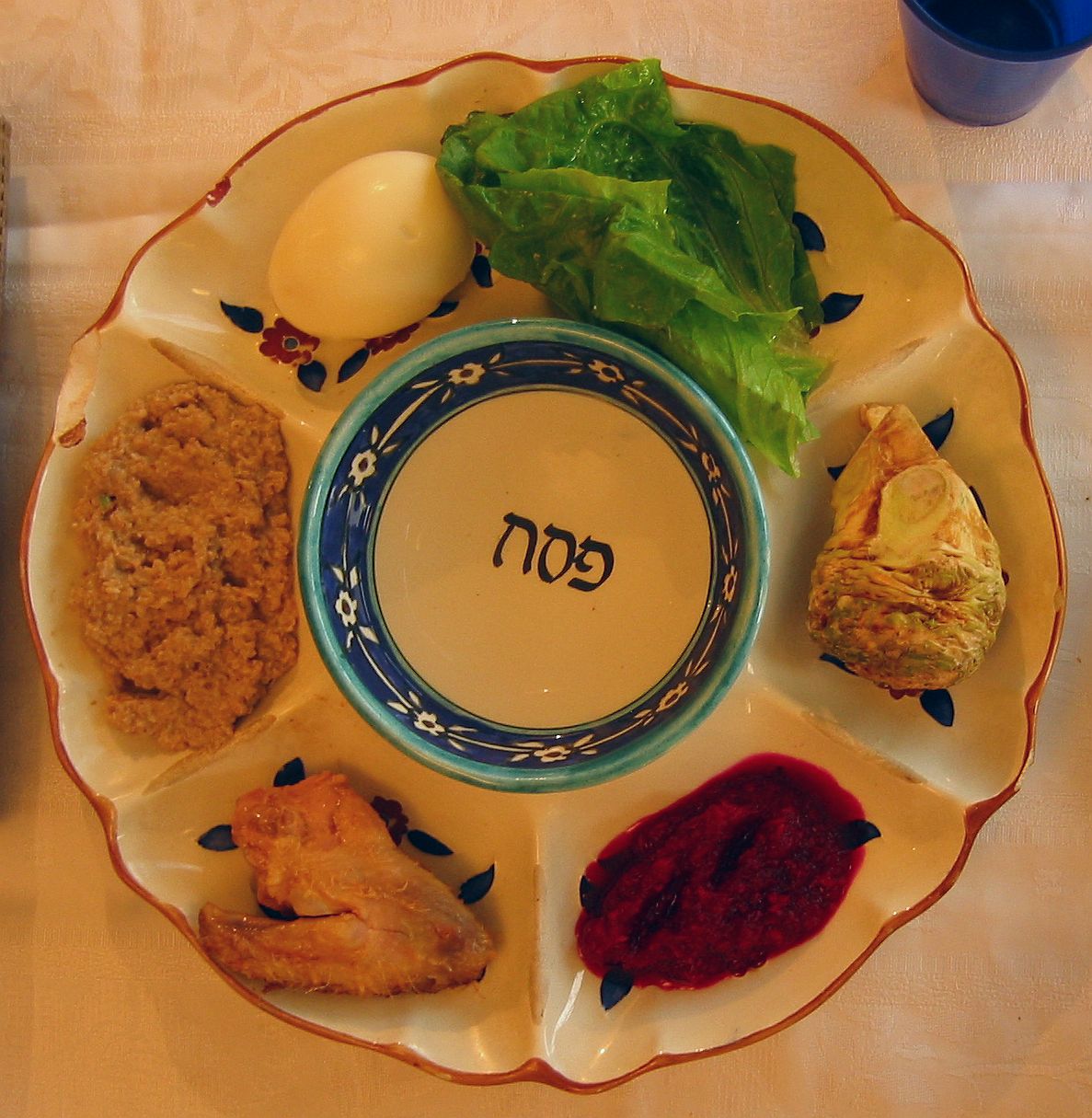 A traditional Pesach or Passover plate. Simple white circle with Hebrew symbol in middle. 
