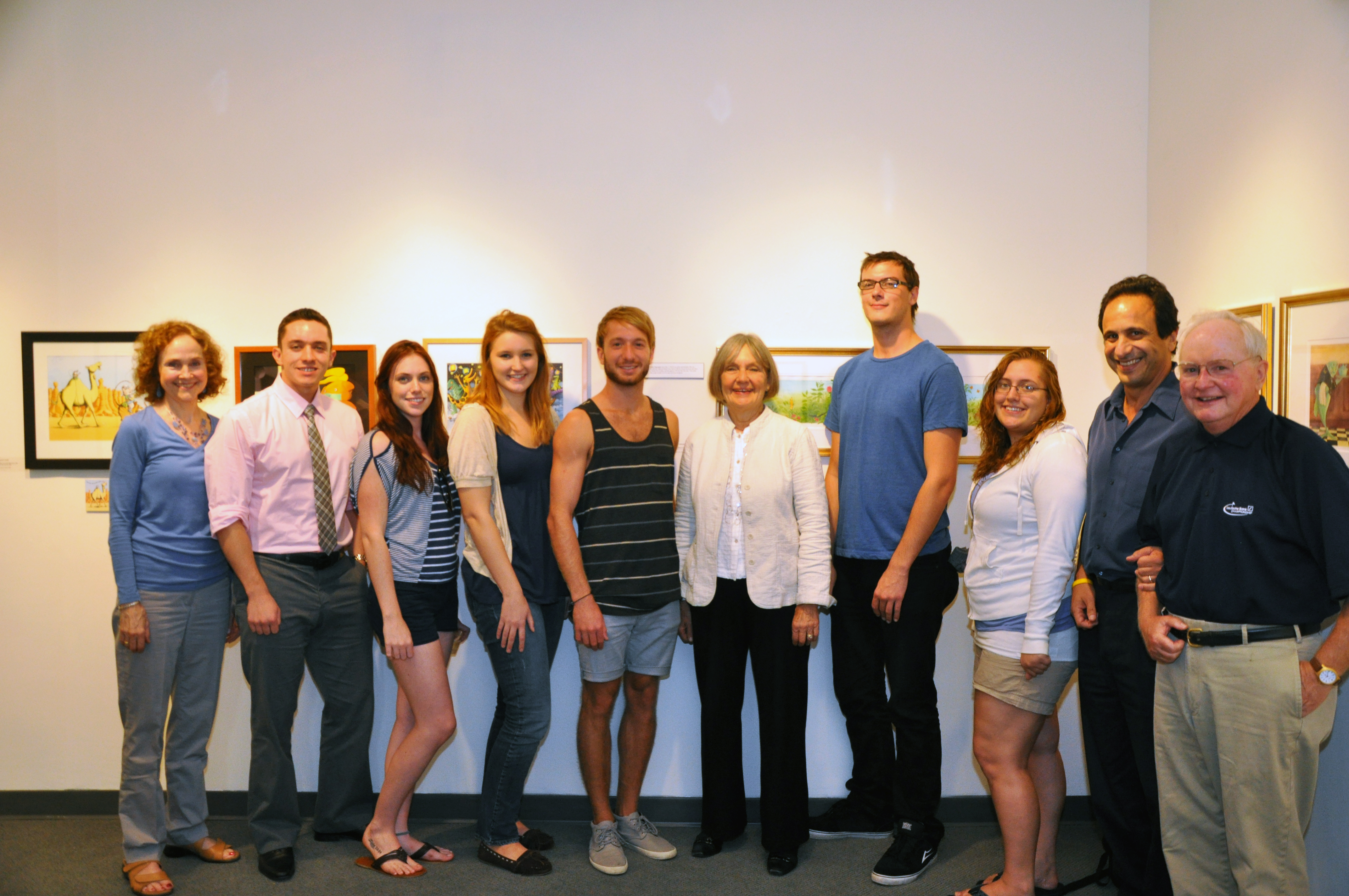 U N E students and faculty pose in the U N E art gallery