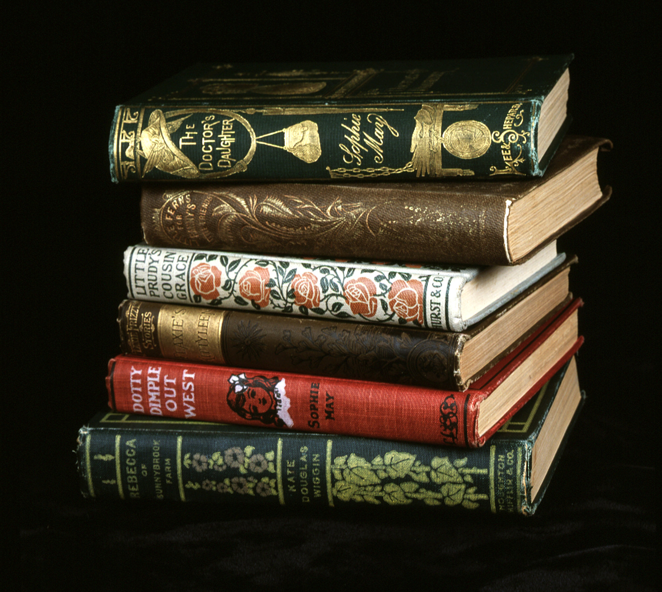 Stacked books from the Maine Women's Writers Collection 