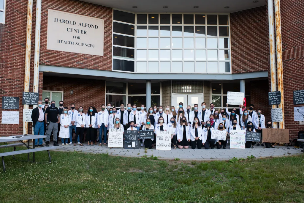 UNE COM students pose following a demonstration for racial equity in health care