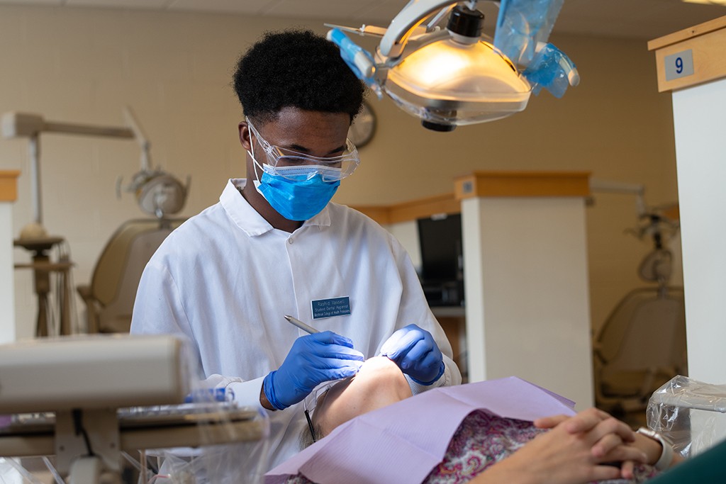 a student works on a patient in the dental hygiene clinic