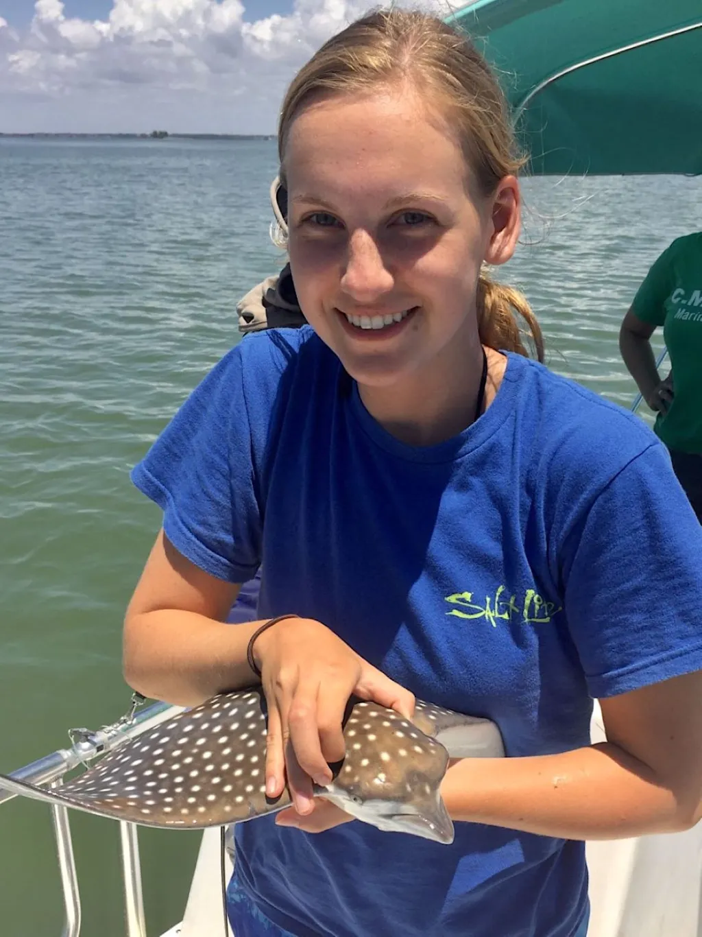 Samantha McPherson holds an eagle ray.